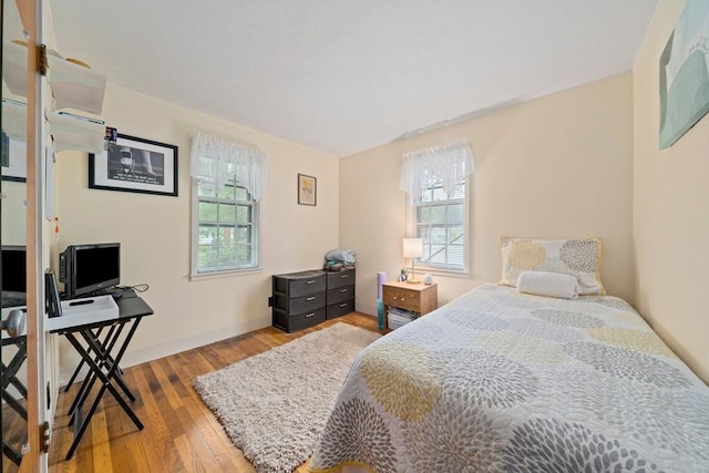 70 Bestick Rd, Braintree, MA 02184 - bedroom with multiple windows, wood finished floors, baseboards, and a desk