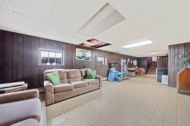 70 Bestick Rd, Braintree, MA 02184 - living area with a paneled ceiling, stairway, wooden walls, and baseboard heating