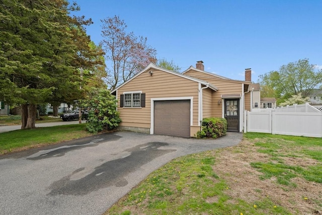 70 Bestick Rd, Braintree, MA 02184 - view of front of property with fence, a chimney, a garage, and asphalt driveway