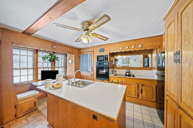 70 Bestick Rd, Braintree, MA 02184 - kitchen with black appliances, a sink, ceiling fan, light countertops, and an island with sink