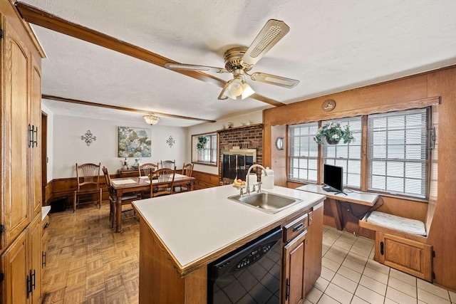 70 Bestick Rd, Braintree, MA 02184 - kitchen with black dishwasher, a sink, wooden walls, a ceiling fan, and a brick fireplace
