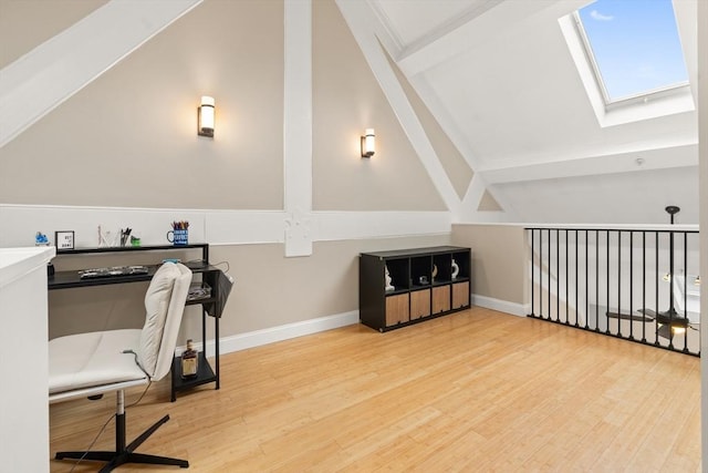28 Broad St Unit 205, Marlborough, MA 01752 - home office featuring a skylight, wood finished floors, lofted ceiling, and baseboards