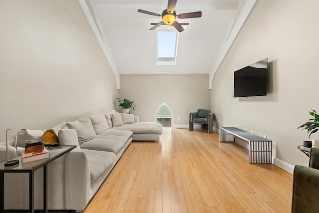 28 Broad St Unit 205, Marlborough, MA 01752 - living room with a ceiling fan, a skylight, vaulted ceiling, light wood-style floors, and baseboards