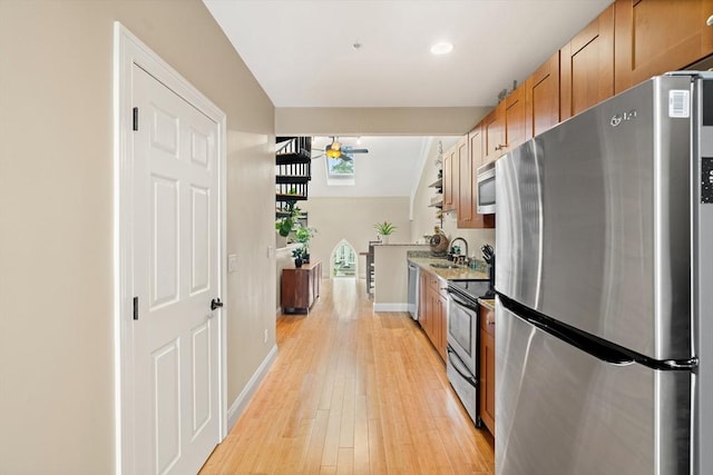 28 Broad St Unit 205, Marlborough, MA 01752 - kitchen featuring appliances with stainless steel finishes, a ceiling fan, light wood-style floors, baseboards, and recessed lighting