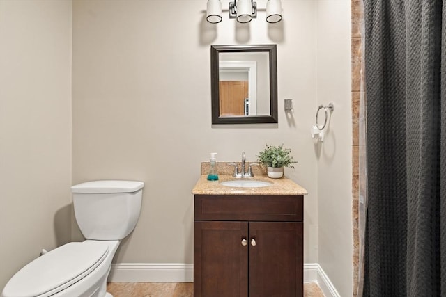 28 Broad St Unit 205, Marlborough, MA 01752 - bathroom featuring baseboards, toilet, vanity, a shower with curtain, and tile patterned floors