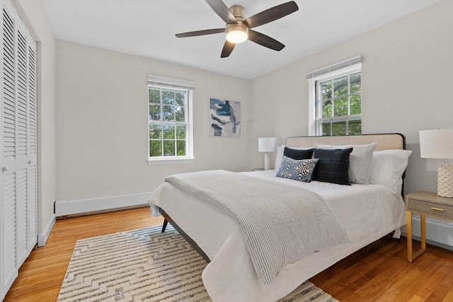 74 Boylston St Unit 2, Newton, MA 02467 - bedroom with multiple windows, wood finished floors, ceiling fan, and baseboards