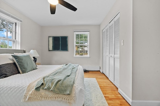 74 Boylston St Unit 2, Newton, MA 02467 - bedroom with light wood-style flooring, baseboards, a closet, and a ceiling fan