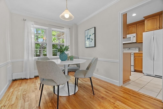 74 Boylston St Unit 2, Newton, MA 02467 - dining room with crown molding, baseboards, and light wood-style floors