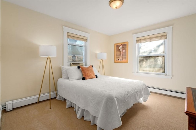 bedroom with carpet floors, a baseboard radiator, multiple windows, and a baseboard heating unit