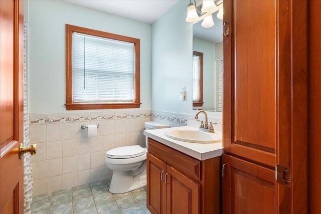 115 Winter St, Whitman, MA 02382 - full bath featuring vanity, wainscoting, tile patterned floors, and tile walls