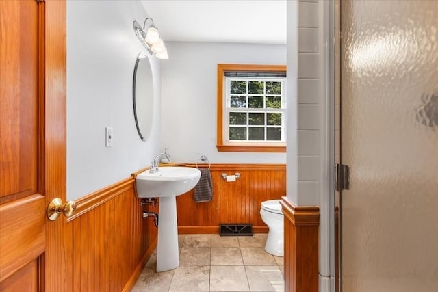 115 Winter St, Whitman, MA 02382 - full bath featuring a stall shower, a wainscoted wall, wooden walls, and tile patterned flooring