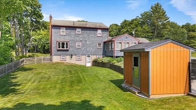 115 Winter St, Whitman, MA 02382 - rear view of house featuring a storage unit, a fenced backyard, and a chimney