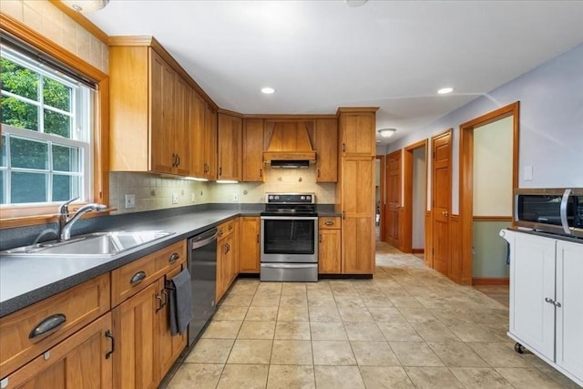 115 Winter St, Whitman, MA 02382 - kitchen with appliances with stainless steel finishes, dark countertops, brown cabinets, decorative backsplash, and recessed lighting