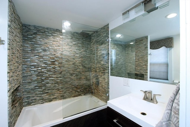 bathroom with vanity and tiled shower / bath combo