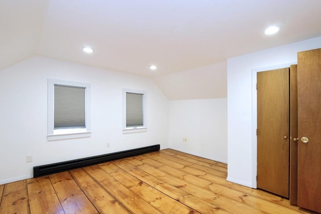 bonus room with vaulted ceiling, baseboard heating, and light hardwood / wood-style flooring