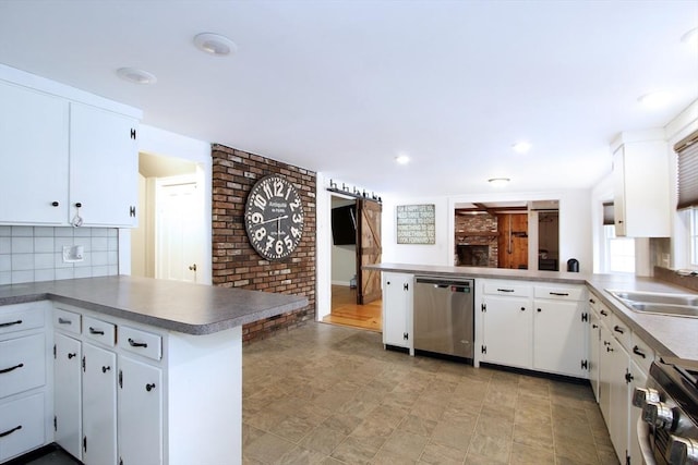 kitchen featuring white cabinetry, dishwasher, backsplash, range, and kitchen peninsula