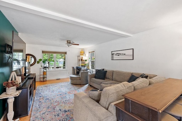 38 Phyllis Ln, Greenfield, MA 01301 - living room featuring beamed ceiling, a ceiling fan, and light wood-style flooring