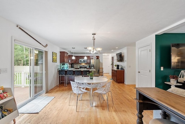38 Phyllis Ln, Greenfield, MA 01301 - dining room with a chandelier, light wood-style floors, and baseboards