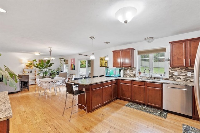 38 Phyllis Ln, Greenfield, MA 01301 - kitchen featuring dishwasher, a sink, a peninsula, tasteful backsplash, and light wood-style flooring