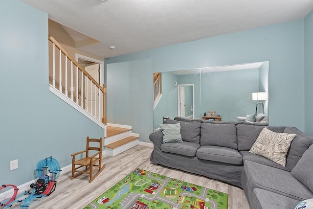 38 Phyllis Ln, Greenfield, MA 01301 - living area with stairs, wood finished floors, and baseboards