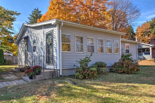 view of side of property with a yard