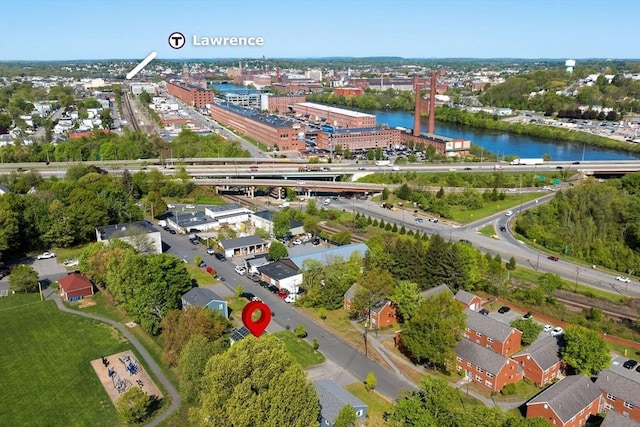 aerial view of property and surrounding area featuring a nearby body of water
