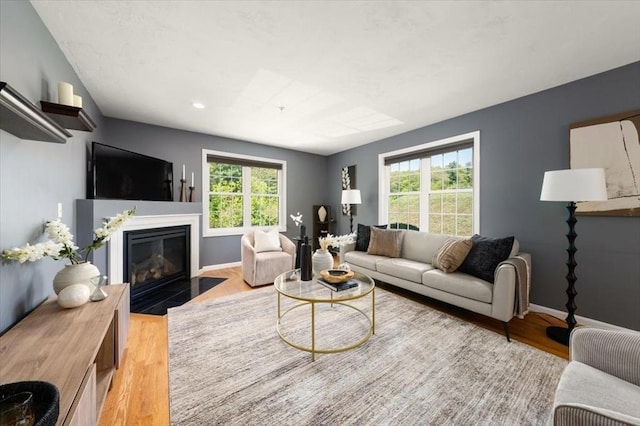 4 Patriots Blvd Unit 4, Hopkinton, MA 01748 - living area with healthy amount of natural light, light wood-style floors, a fireplace with flush hearth, baseboards, and recessed lighting