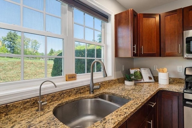 4 Patriots Blvd Unit 4, Hopkinton, MA 01748 - kitchen with a sink, light stone counters, and stainless steel microwave