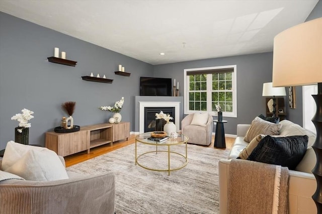 4 Patriots Blvd Unit 4, Hopkinton, MA 01748 - living room with wood finished floors, a glass covered fireplace, and baseboards