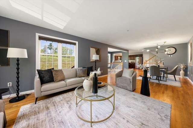 4 Patriots Blvd Unit 4, Hopkinton, MA 01748 - living area featuring wood finished floors, baseboards, and a chandelier