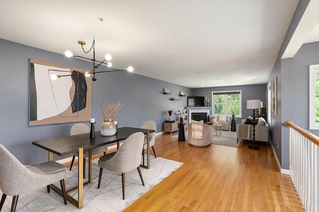 4 Patriots Blvd Unit 4, Hopkinton, MA 01748 - dining space featuring light wood-style floors, a chandelier, a fireplace, and baseboards