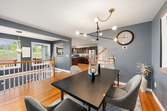4 Patriots Blvd Unit 4, Hopkinton, MA 01748 - dining area with light wood-style floors, a chandelier, and baseboards