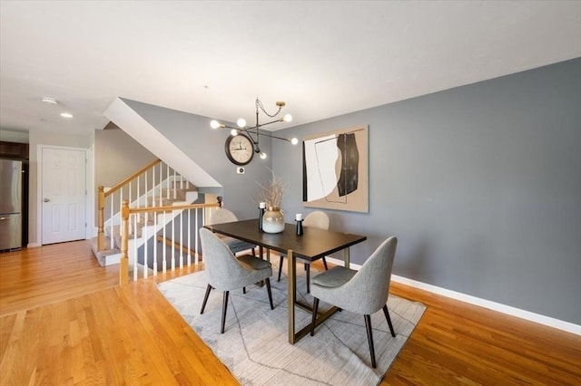 4 Patriots Blvd Unit 4, Hopkinton, MA 01748 - dining space featuring stairs, a chandelier, light wood finished floors, and baseboards