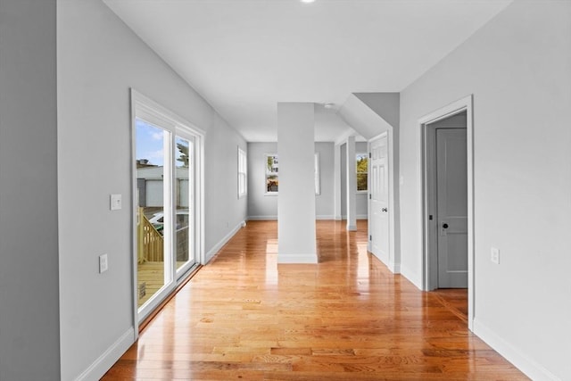 hallway with light wood-style floors and baseboards