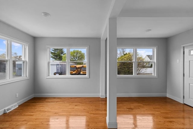 entryway featuring plenty of natural light, light wood finished floors, and baseboards