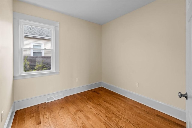 unfurnished room with wood finished floors and baseboards