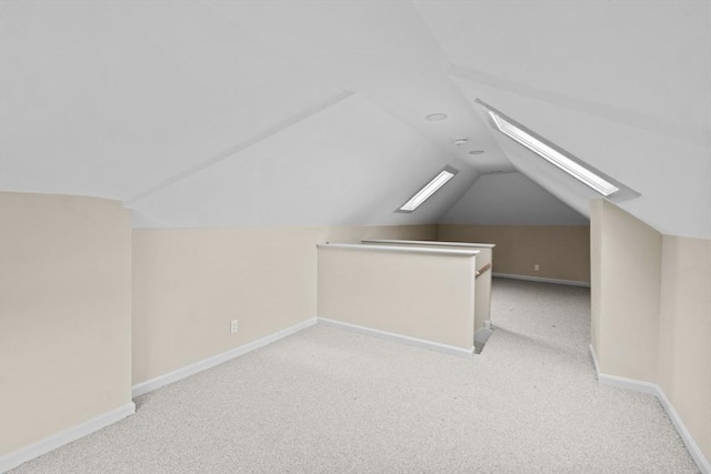 bonus room featuring baseboards, carpet floors, and vaulted ceiling