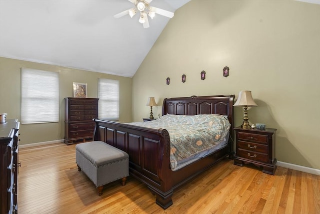 bedroom featuring light wood-style floors, baseboards, a ceiling fan, and vaulted ceiling