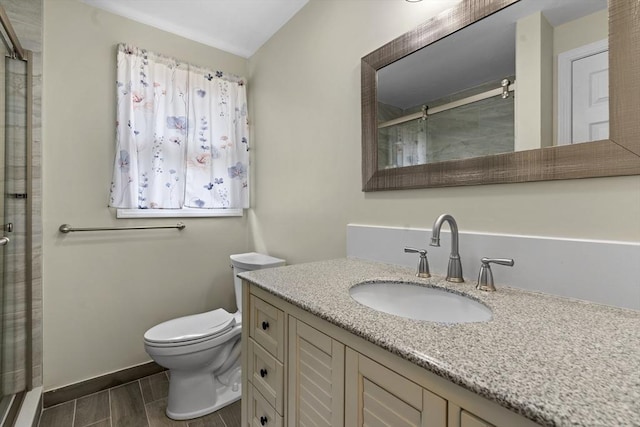 full bathroom with vanity, wood finish floors, toilet, and a shower stall