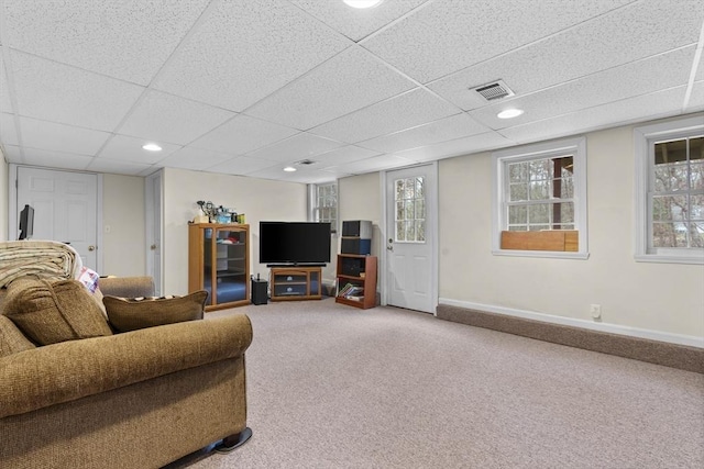 carpeted living room featuring visible vents, baseboards, and a drop ceiling