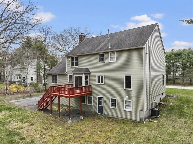 rear view of property featuring stairs, a deck, a chimney, cooling unit, and a yard