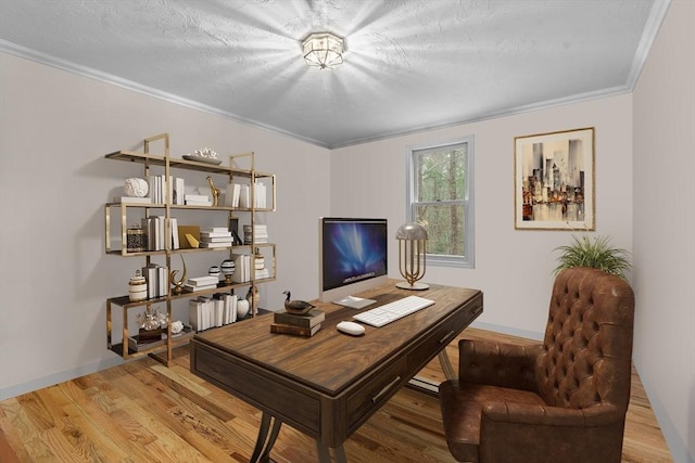 home office featuring crown molding, baseboards, and wood finished floors