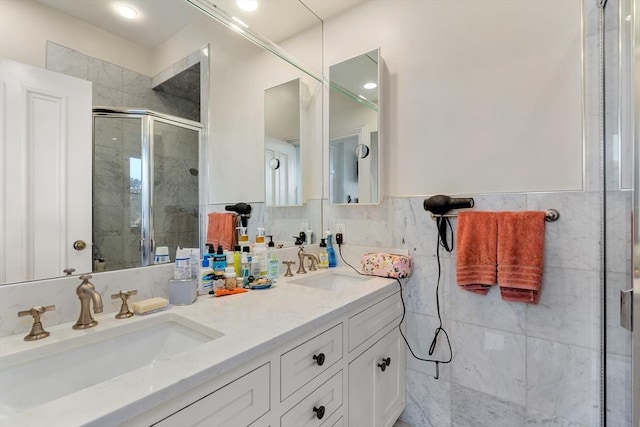 bathroom featuring a sink, double vanity, and a stall shower