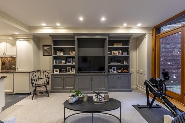 living area featuring carpet flooring, ornamental molding, and recessed lighting
