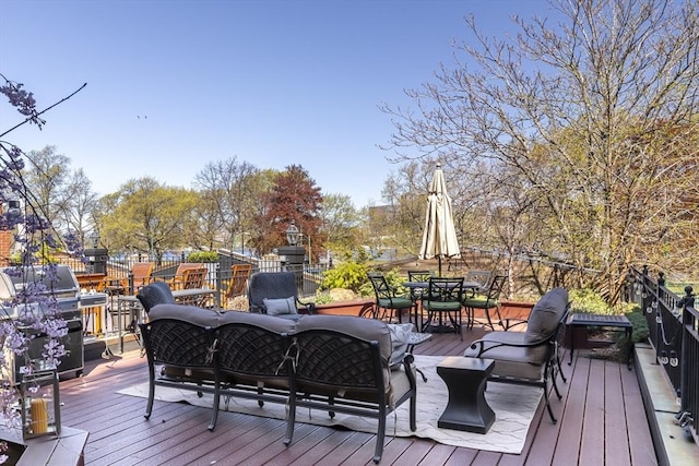 wooden deck with outdoor lounge area, outdoor dining area, and grilling area