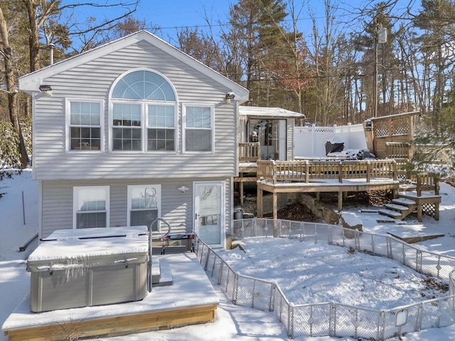 view of front facade featuring a hot tub and a wooden deck