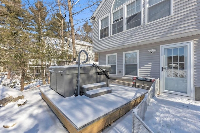 snow covered patio with a hot tub