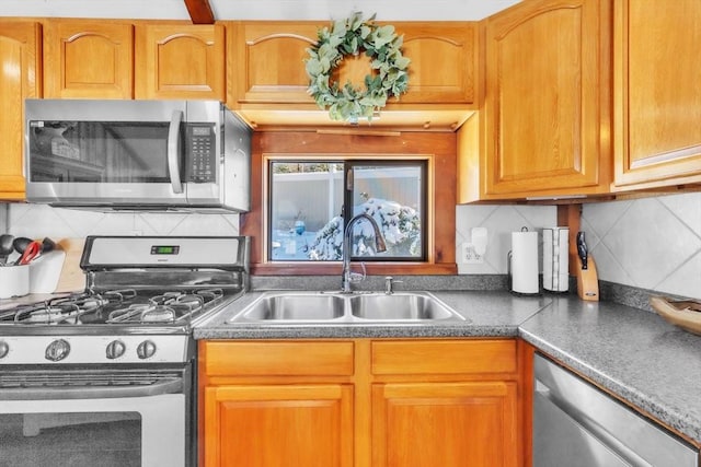 kitchen featuring sink, backsplash, and appliances with stainless steel finishes