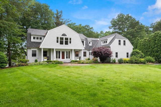 9 Twig Rush Ln, West Newbury, MA 01985 - view of front of property featuring a front yard, a gambrel roof, a shingled roof, and a porch