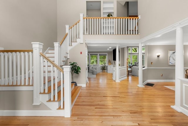 9 Twig Rush Ln, West Newbury, MA 01985 - entryway featuring light wood finished floors, stairs, a high ceiling, and ornamental molding